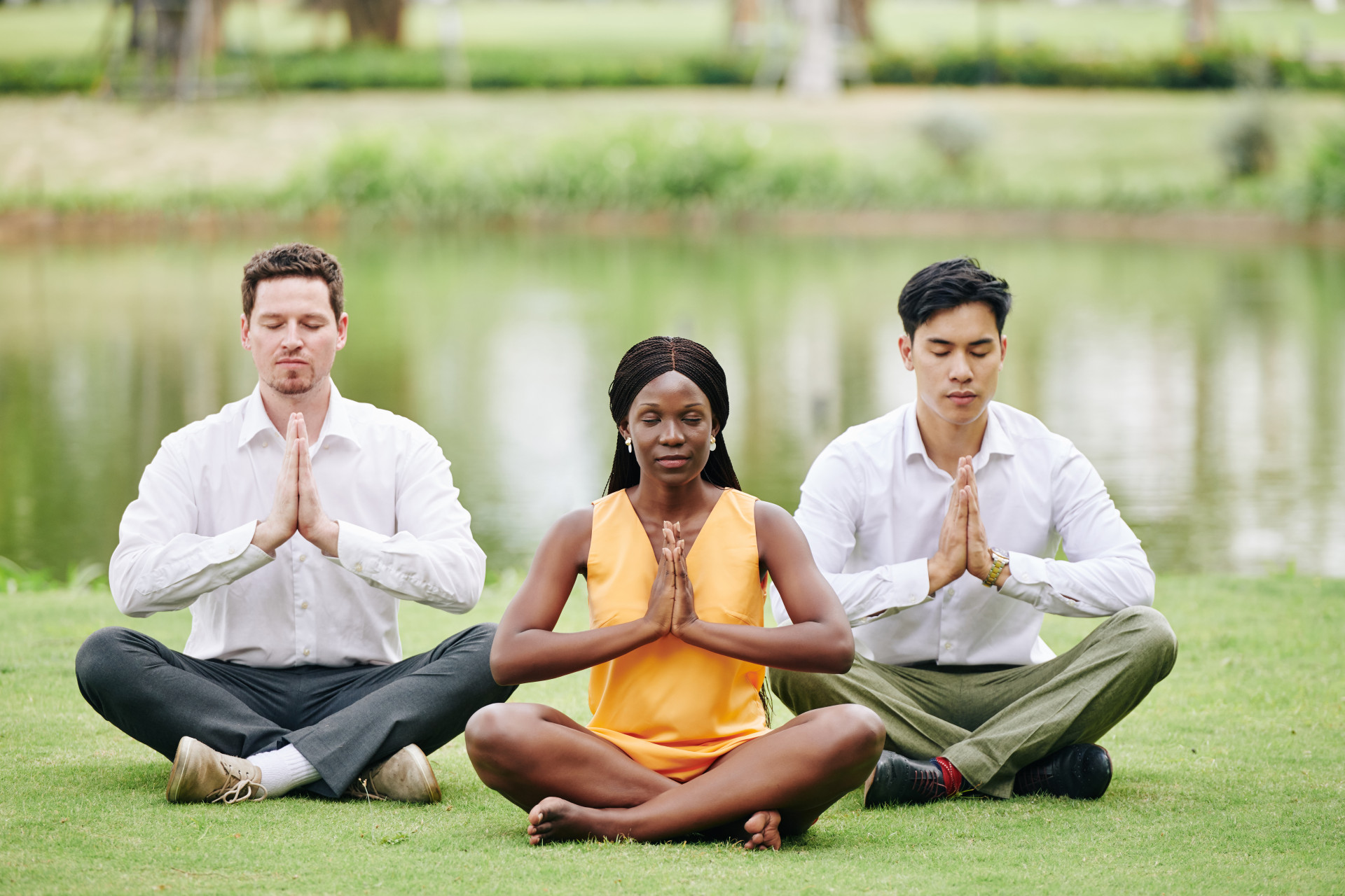business team medicating in a park