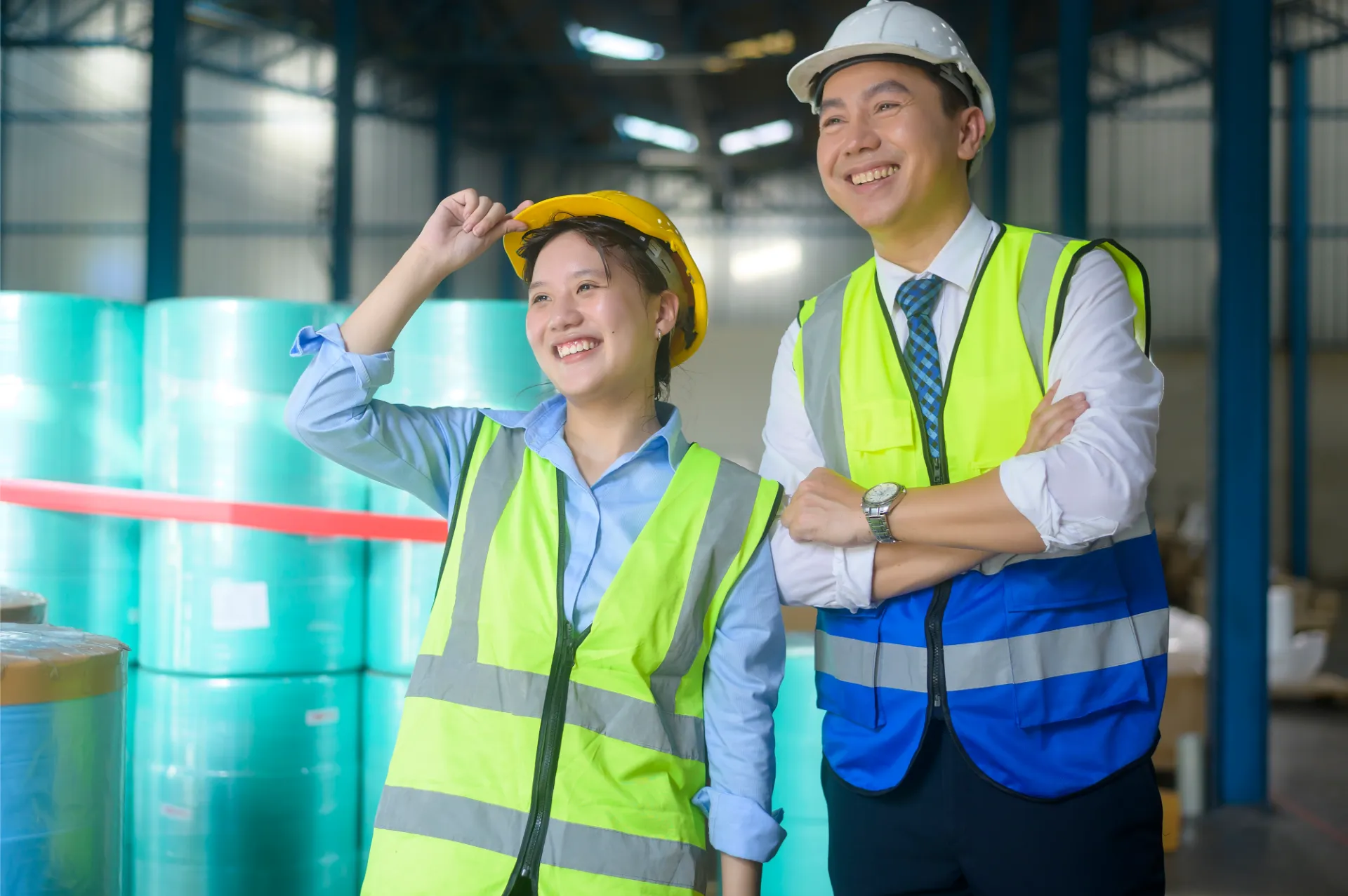 smiling Asian couple wearing work vests