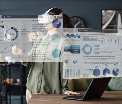 Person wearing VR googles working with display screens.