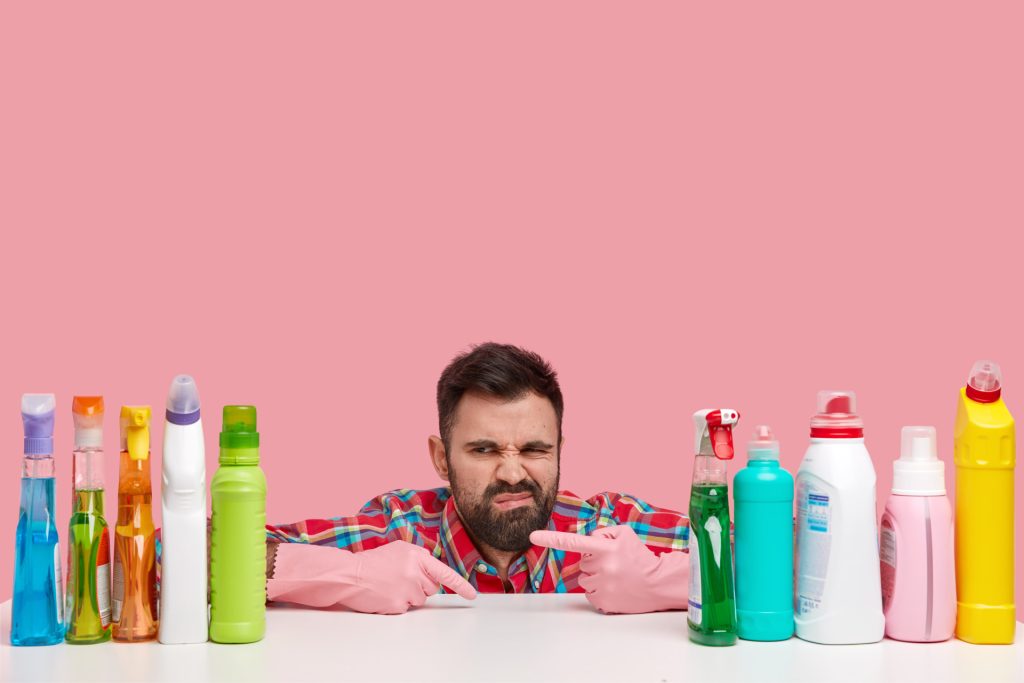 Frowning man pointing to plastic bottles