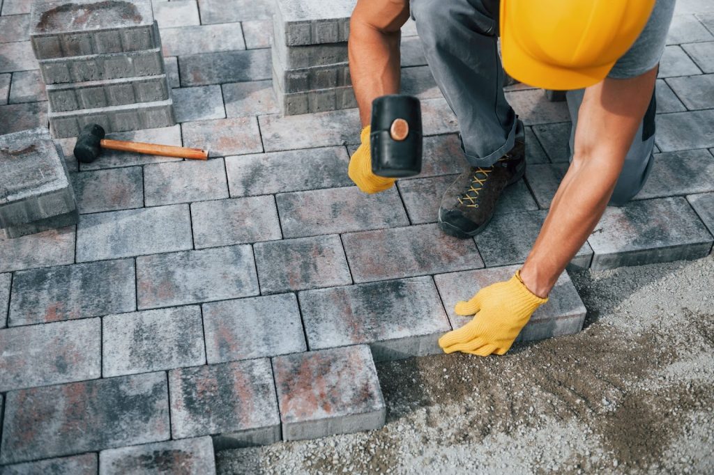 Worker laying concrete blocks