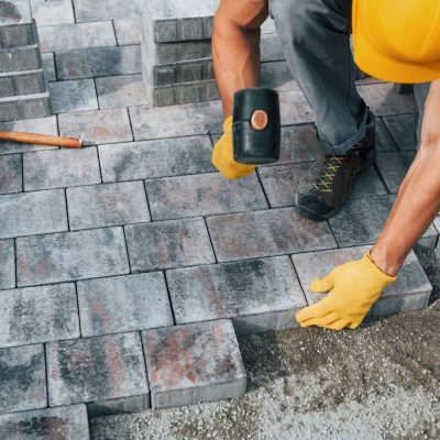 Worker laying concrete blocks