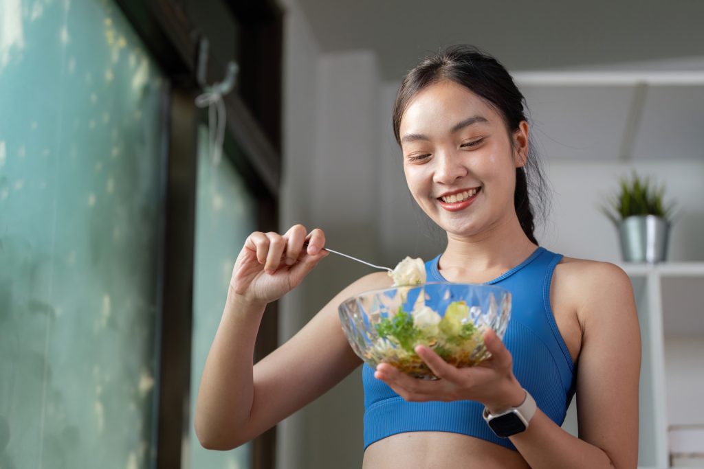 smiling woman preparing a fresh salad highlightin 2026 01 09 00 01 12 utc